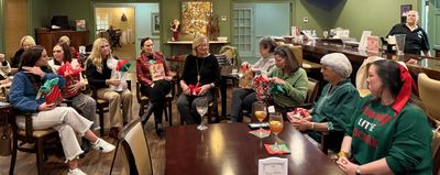 Everyone gathered in the Bar for the ornament exchange activity.